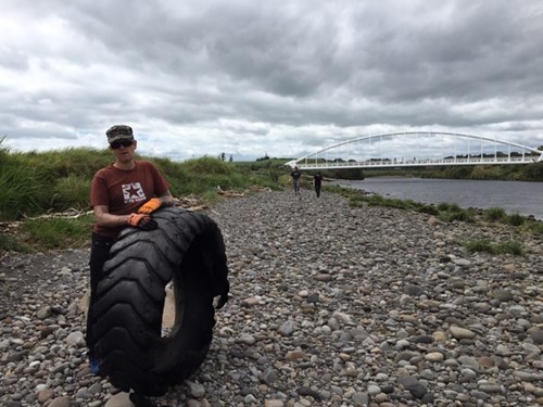 Powerco team member with tractor tyre