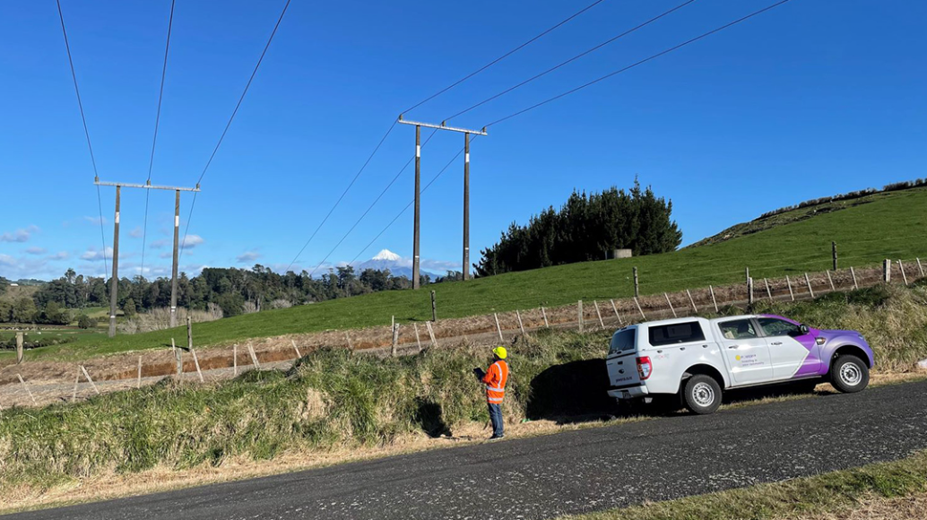 Powerco engineer using a device in the field to collect asset data.