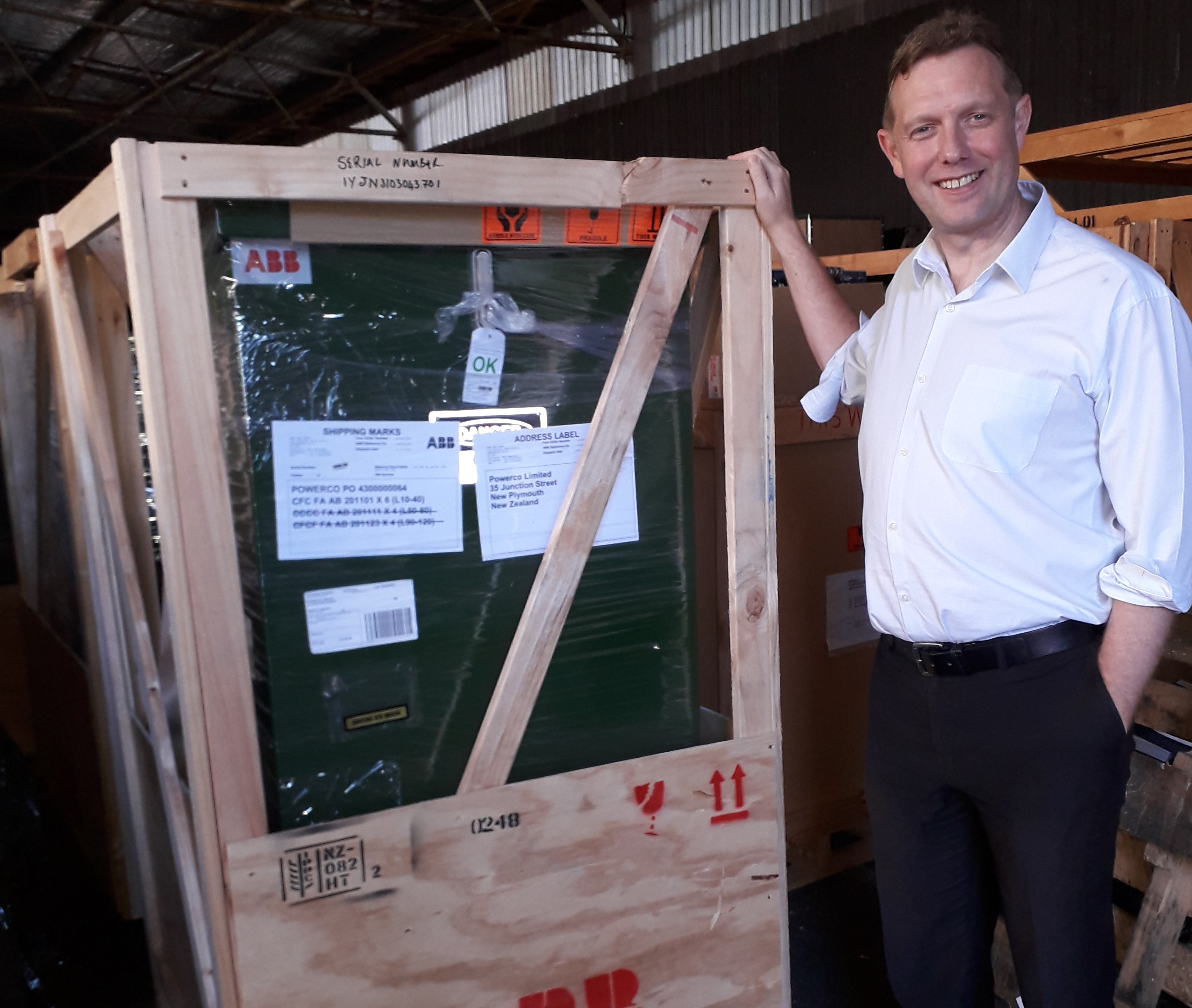 Powerco team member with strategic spare part in a crate.